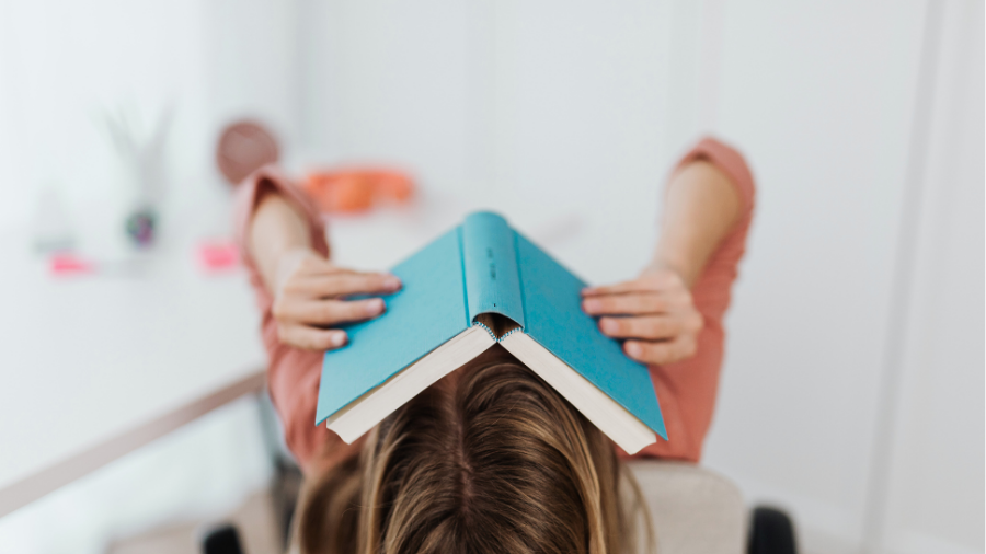 Kind hat Buch über Kopf